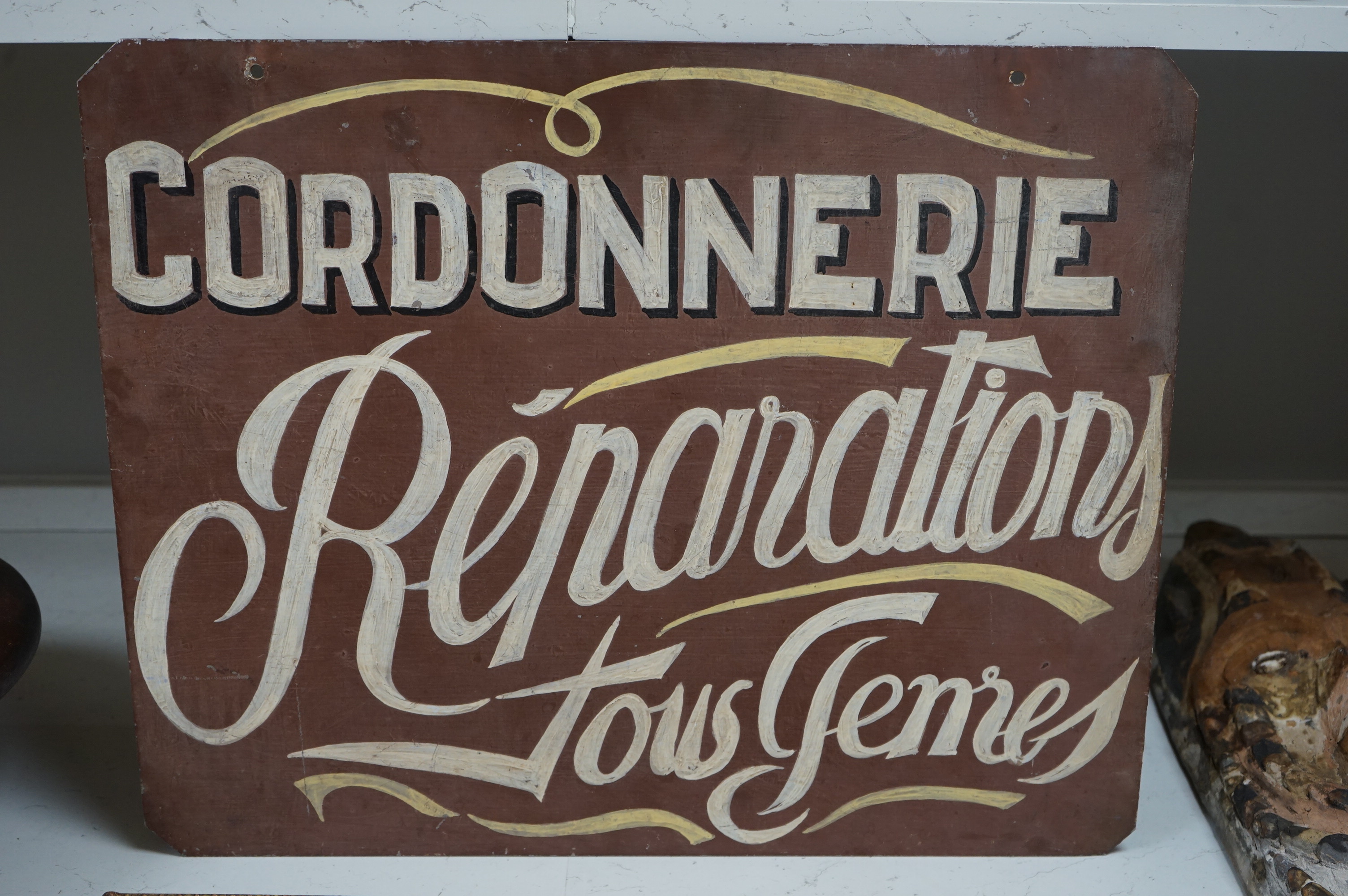 A painted French metal advertising sign ‘Cordonnerie’. 56.5cm wide x 45.5cm high. Condition - good